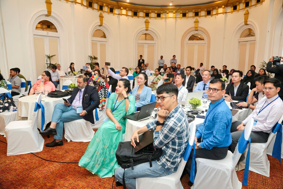 Conference participants from across the region seated together during a plenary session