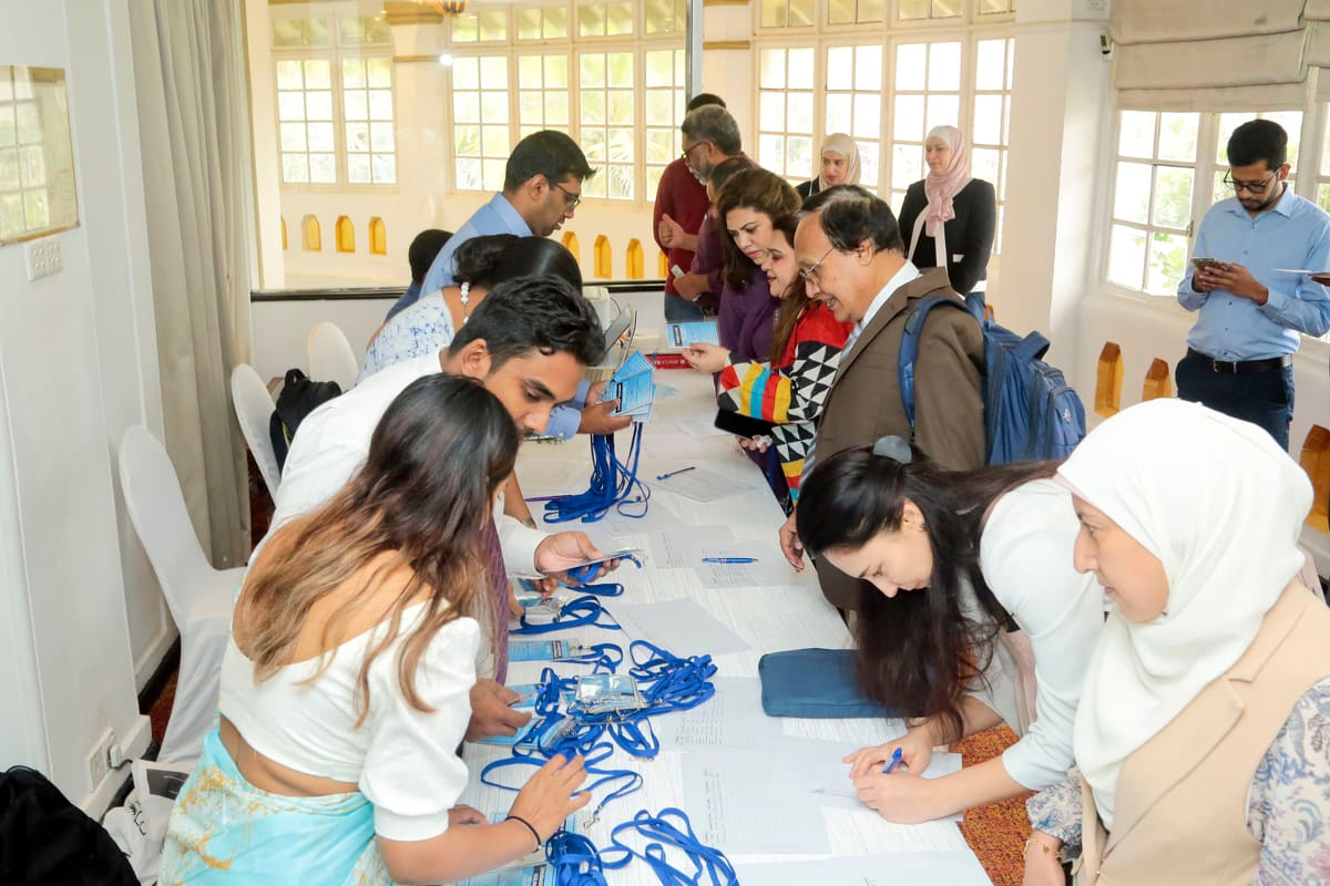 Delegates and event staff gathered around the conference registration desk