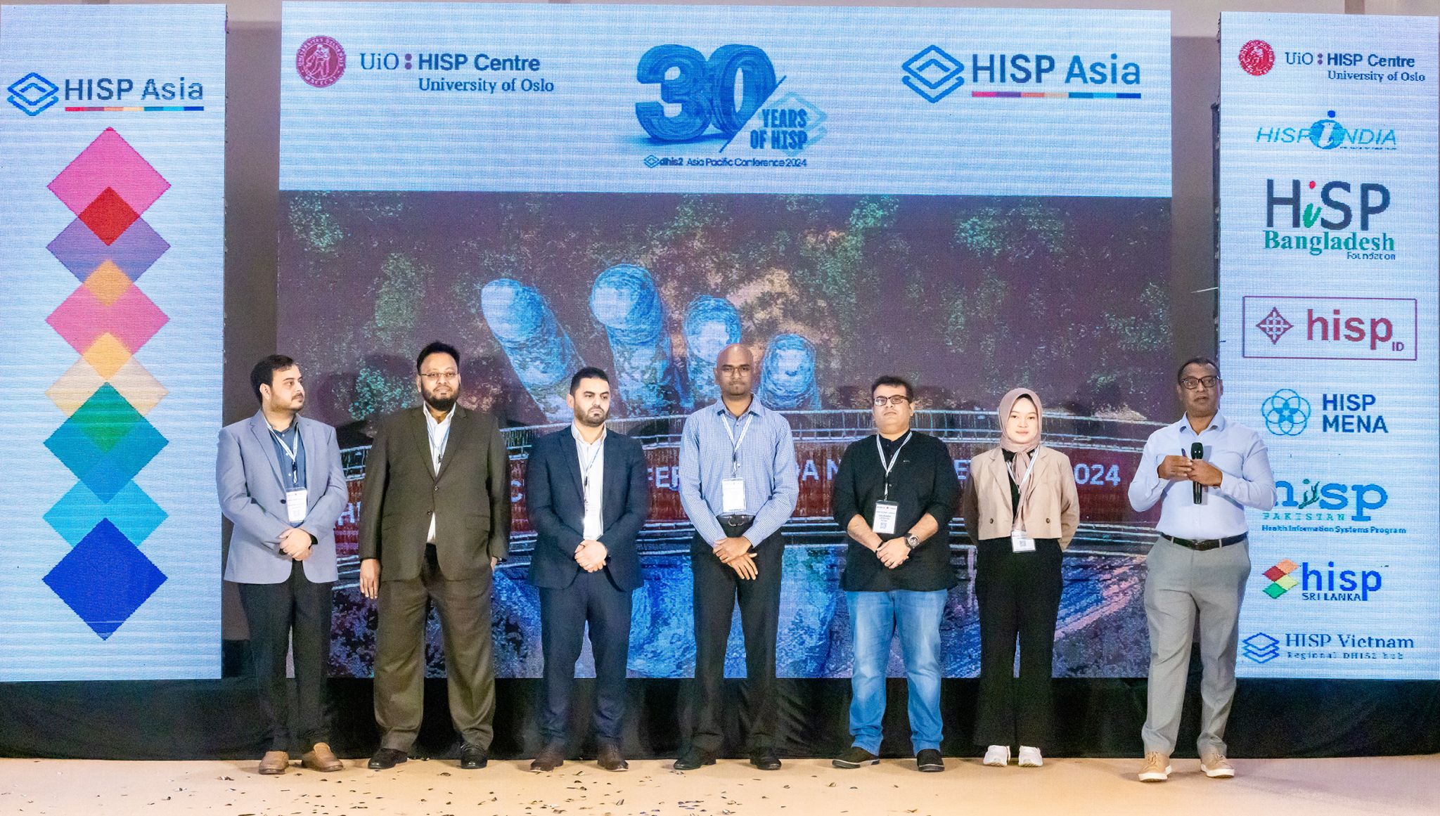 Speakers on stage between HISP Asia and HISP network banners at the 2024 conference