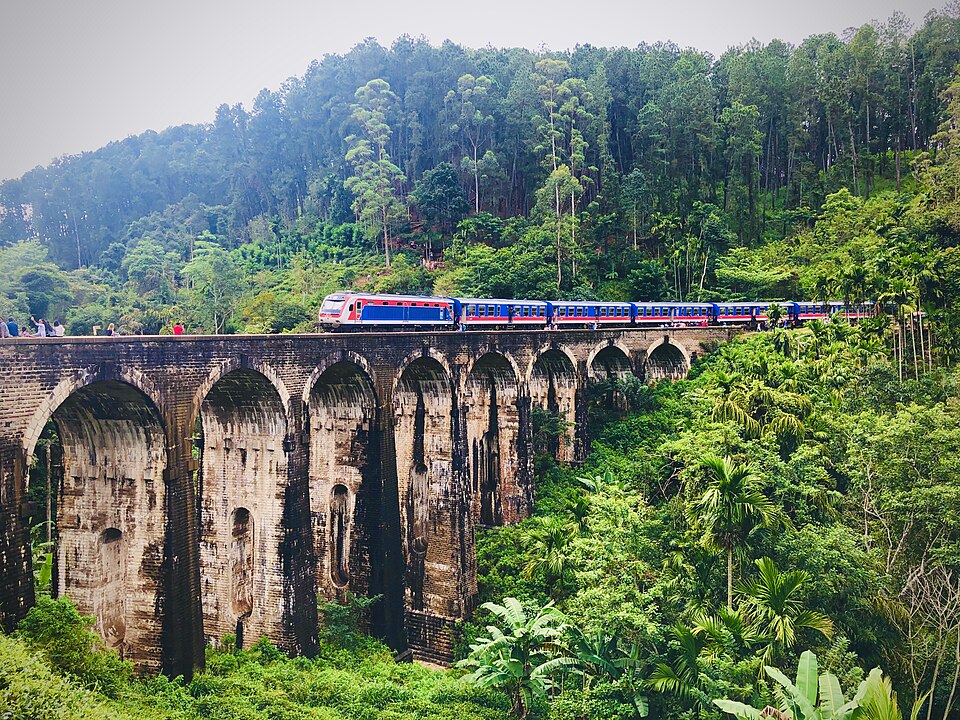 Train crossing the stone arches of Nine Arch Bridge near Ella