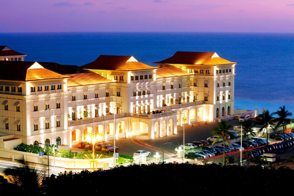Galle Face Hotel illuminated at dusk with the Indian Ocean behind it
