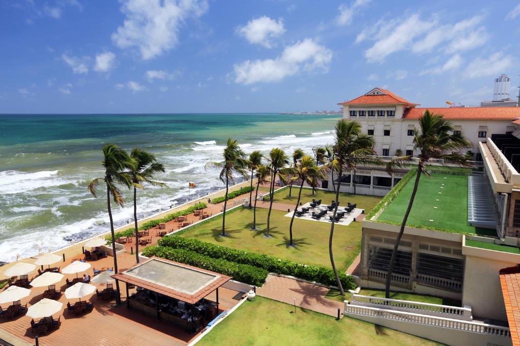Galle Face Hotel's oceanfront lawn and terrace lined with palm trees